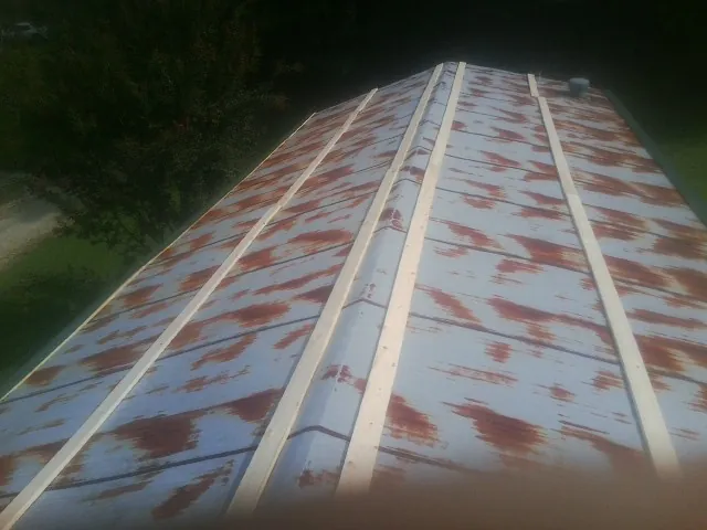 Rusted metal roof panels with new wood purlins before replacement — Storm Damage Roof Repair in New Galilee by Roofing Brothers