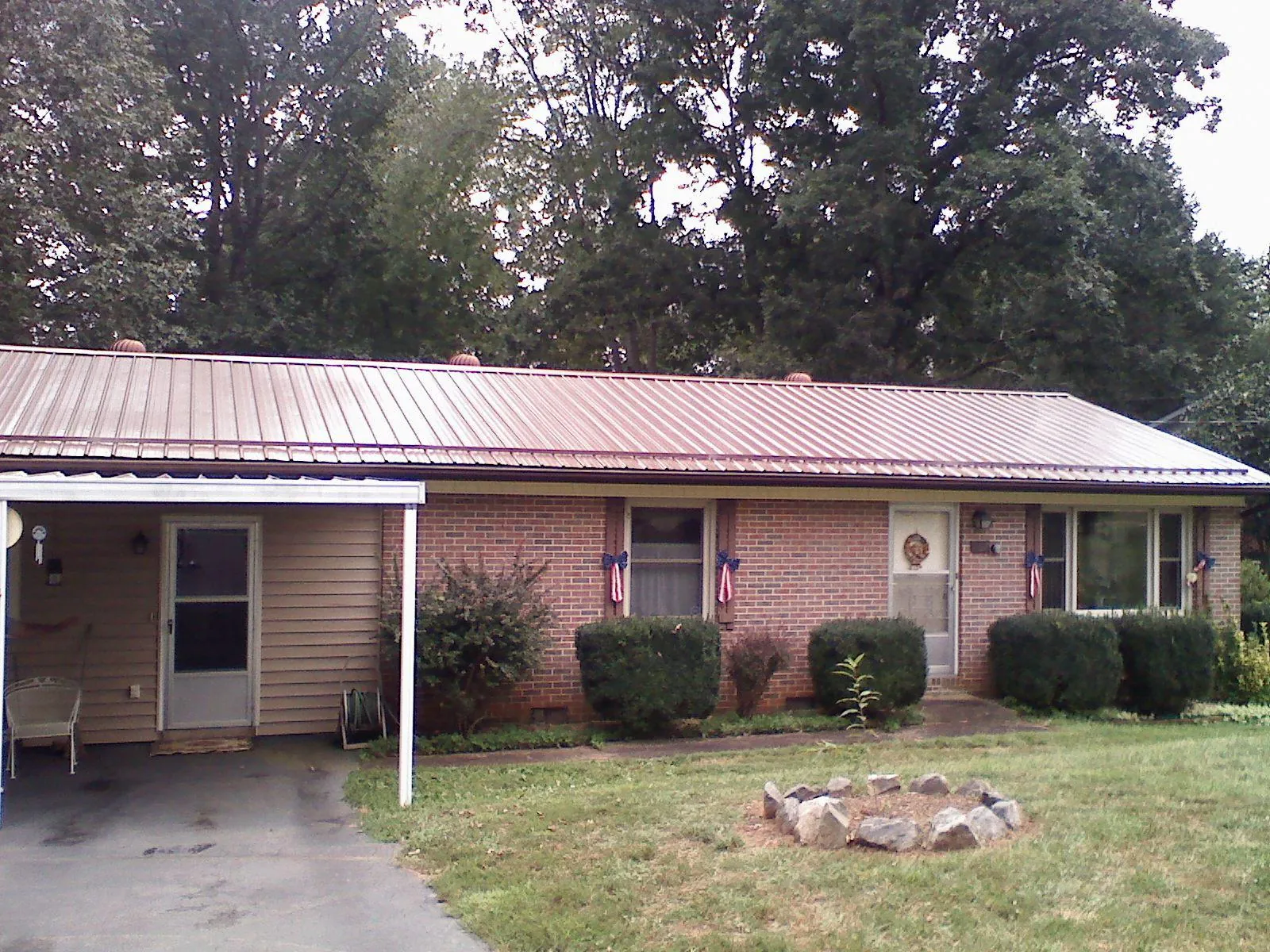 Bronze metal roof and carport on a brick ranch home — Roof Repair work by our crew in New Galilee