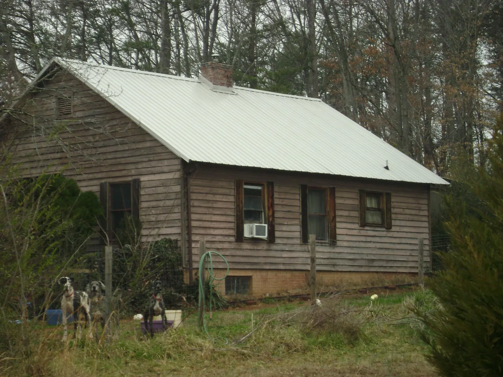 White metal roof on an old wood sided farmhouse, from a Metal Roof Installation job in New Galilee
